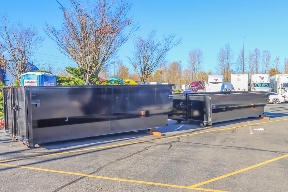 Professional dumpster rental service with roll-off container on residential driveway in Morrow